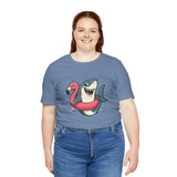 Blue crew-neck T-shirt with shark and flamingo graphic; worn with jeans
