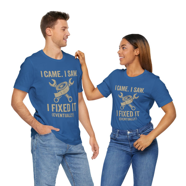 Two people wearing blue crewneck T-shirts with gold “I Came, I Saw… I Fixed It (Eventually)” print.