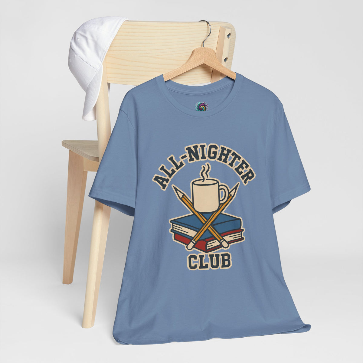 Blue crew-neck T-shirt with “All-Nighter Club” coffee-and-books graphic on hanger