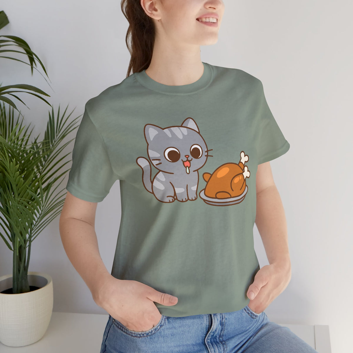 Sage green crew-neck T-shirt with gray cat and orange turkey cartoon on chest