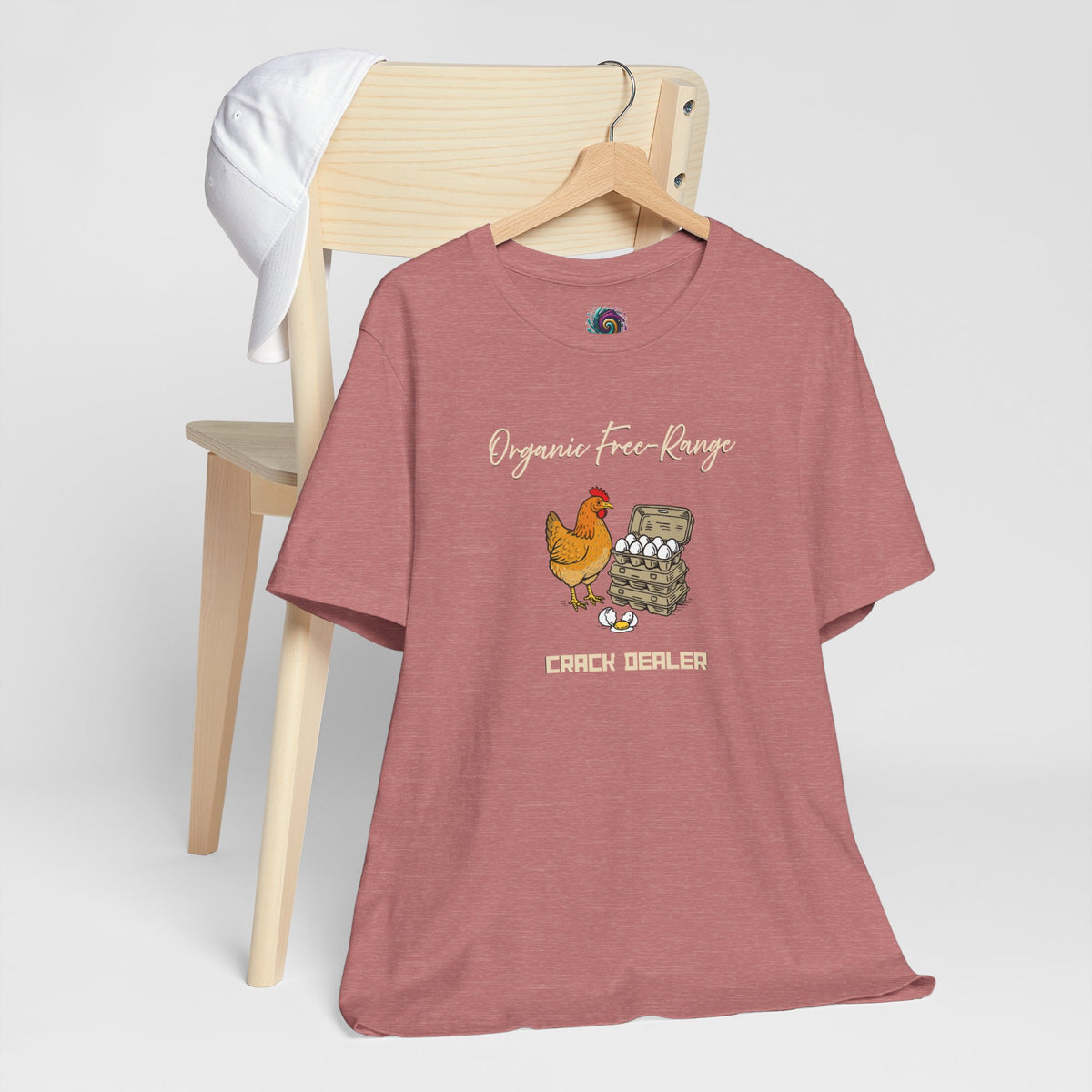 Rose mauve crew-neck T-shirt with chicken and egg dealer graphic on hanger