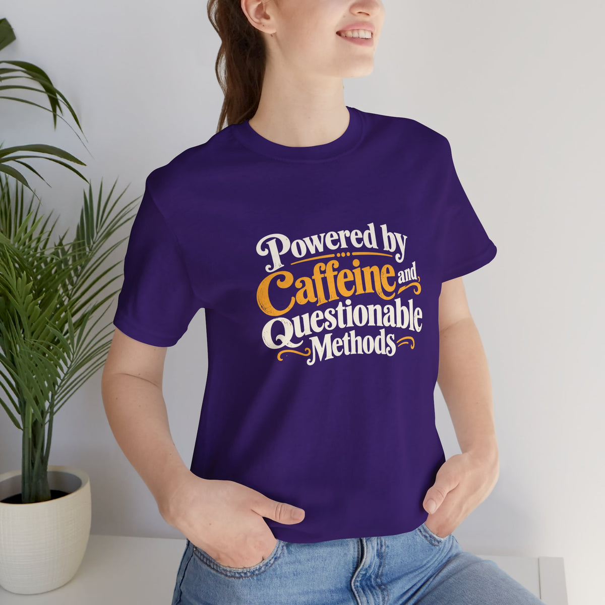 Purple crew-neck graphic T-shirt with Caffeine and Questionable Methods print, side view