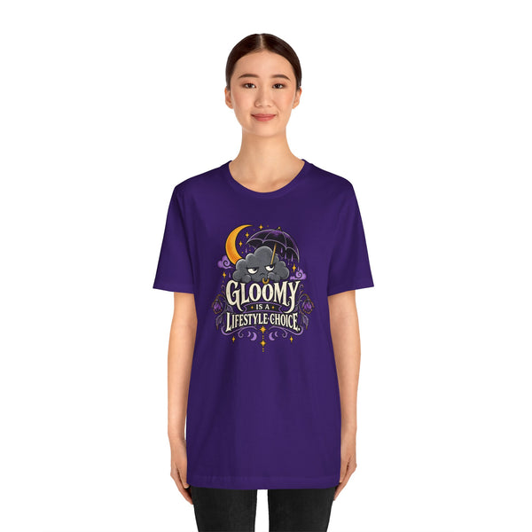 Purple graphic t-shirt with cartoon bat and 'Gloomy' logo print on chest