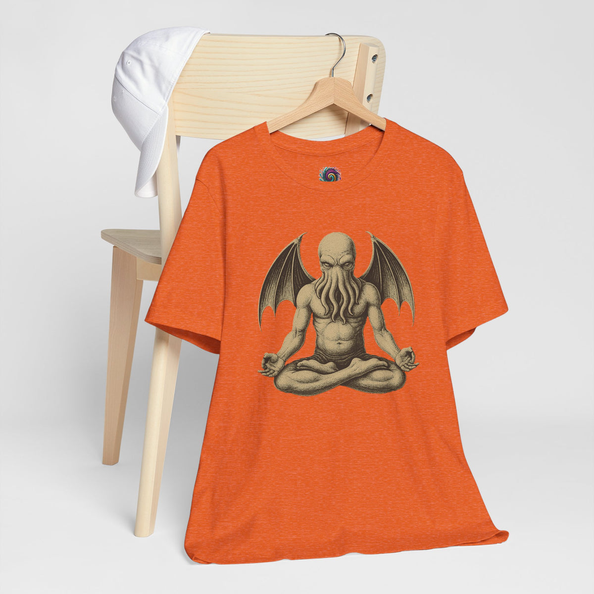 Orange unisex crewneck t-shirt with meditating Cthulhu graphic on front