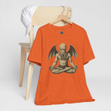 Orange unisex crewneck t-shirt with meditating Cthulhu graphic on front