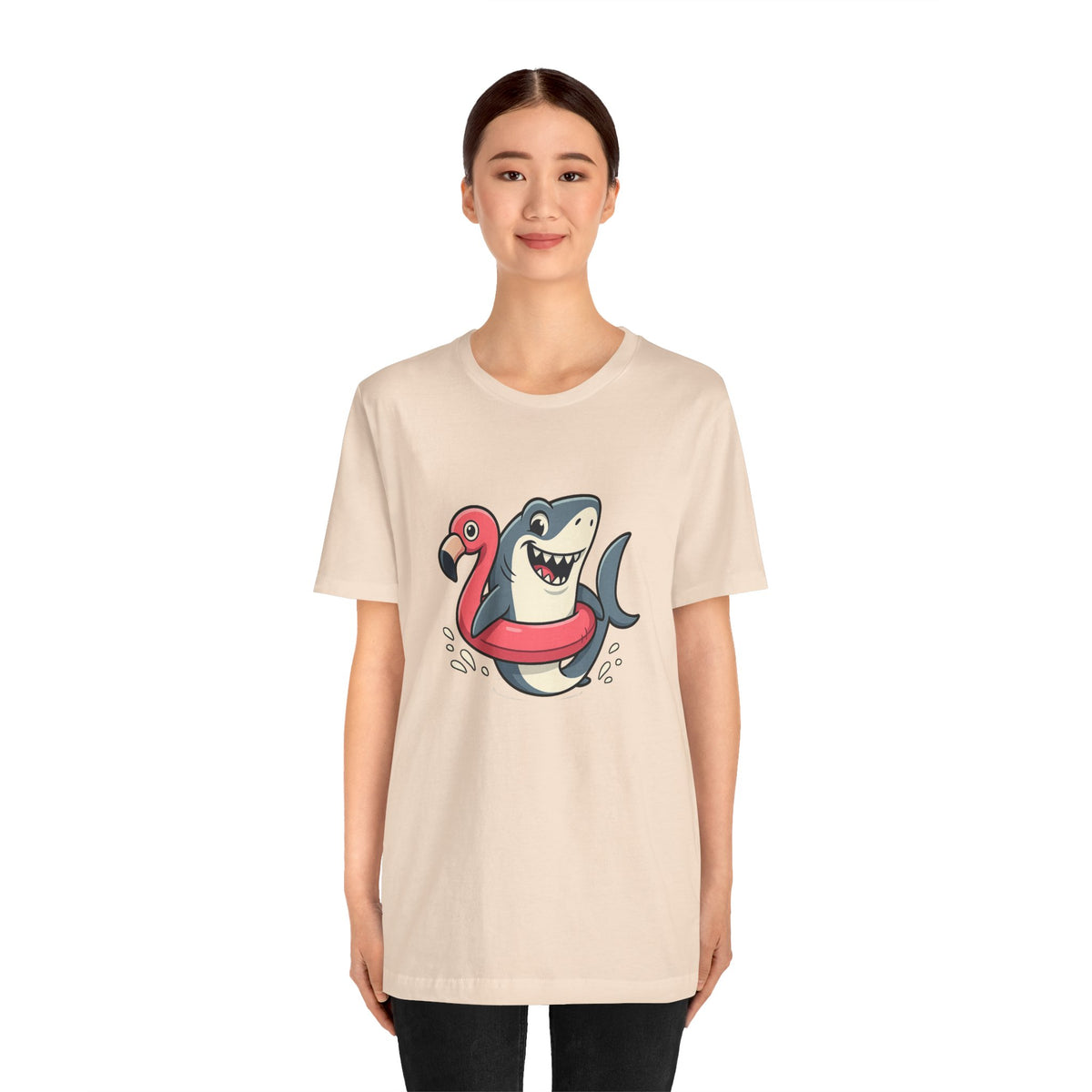 Cream crew-neck t-shirt with shark and flamingo graphic, front view on model