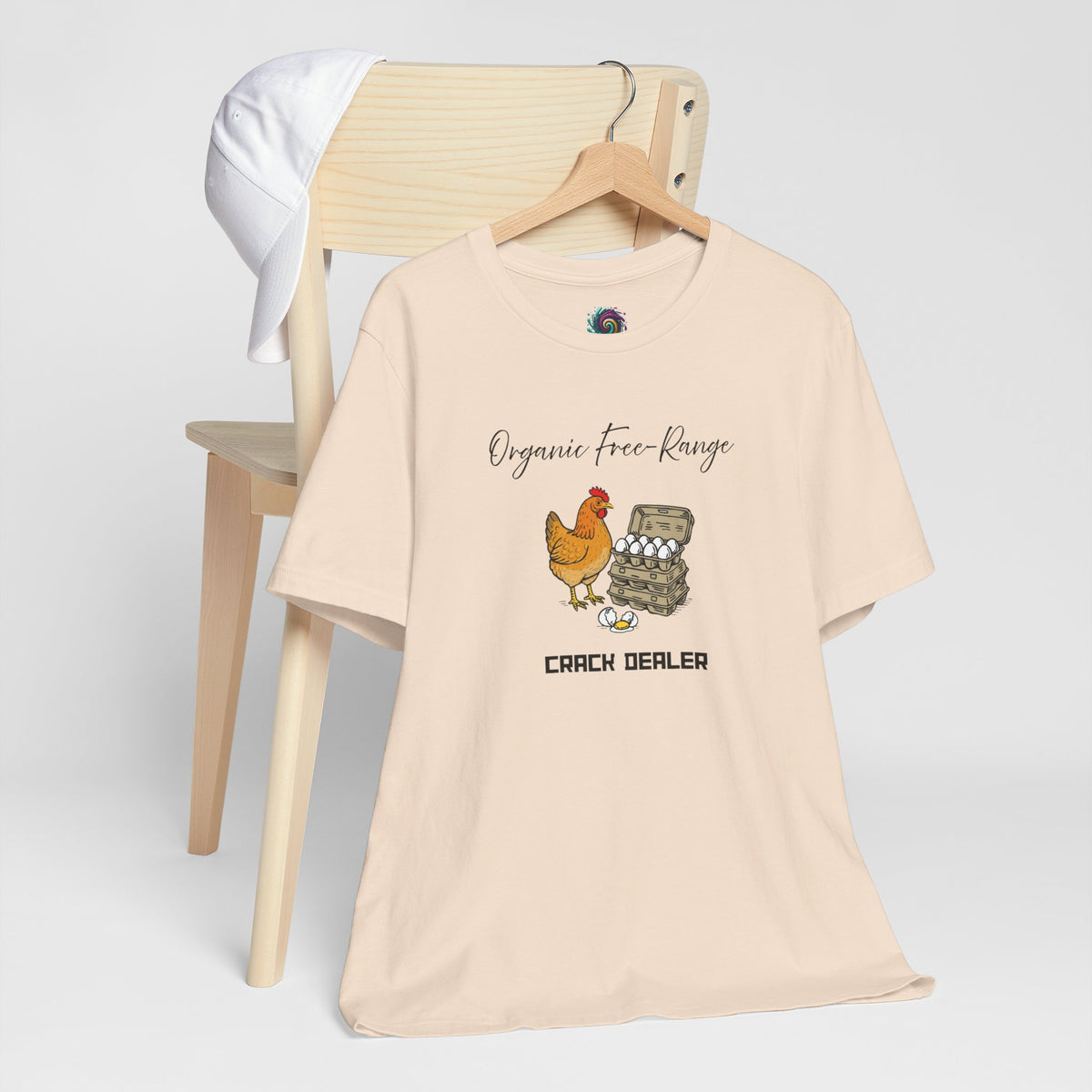 Light beige chicken graphic T-shirt on hanger with 'Organic free-Range' and 'CRACK DEALER'