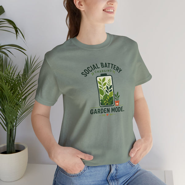 Sage green crew-neck T-shirt with garden-themed “SOCIAL BATTERY” graphic