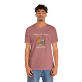 Rose mauve crew-neck T-shirt with chicken and egg dealer graphic, worn by man