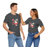 Couple wearing dark gray t-shirts with front shark and pink flamingo floatie graphic