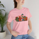 Pink T-shirt with dinosaur Valentine graphic, crew neck, short sleeves on model