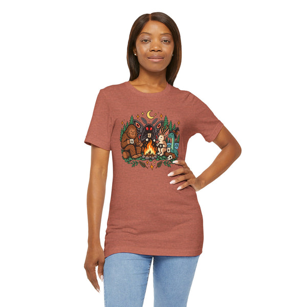 Rust-brown crewneck T-shirt with campfire cryptids print, model hand on hip
