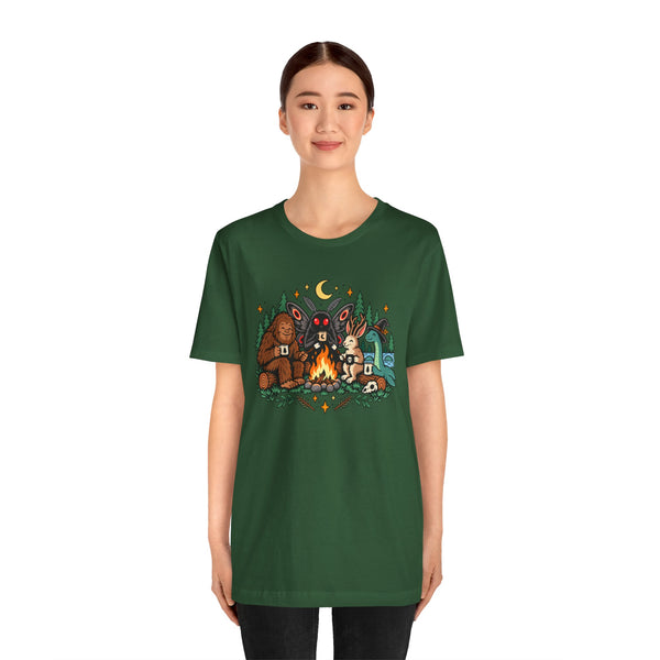 Dark green crewneck T-shirt with colorful campfire cryptid graphic on the chest