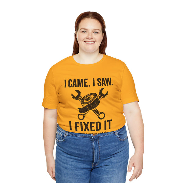 Orange crew-neck T-shirt featuring black repair tools graphic and quote lettering