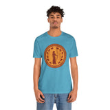 Light blue crewneck T-shirt with orange circular Greek-style goddess graphic, front view