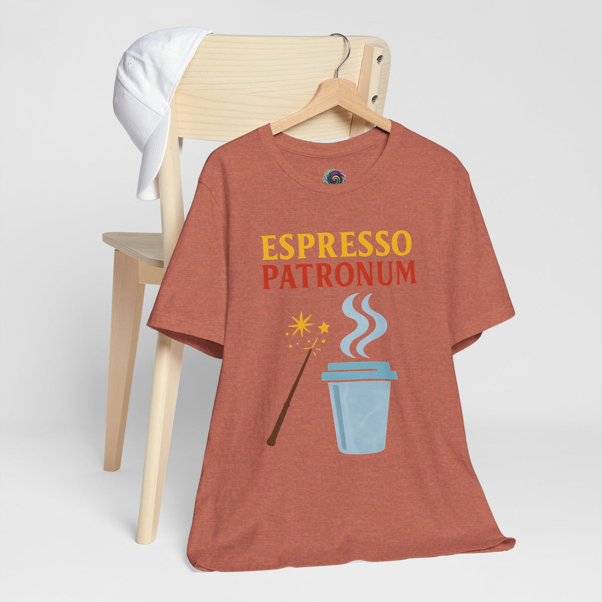 Mauve T-shirt on wooden hanger with "Espresso Patronum" coffee cup graphic