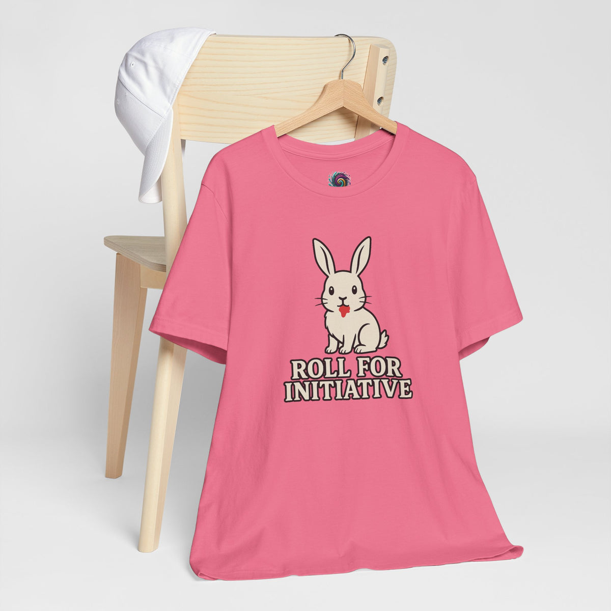 Pink T-shirt with bunny graphic and “Roll for Initiative” text, on a hanger