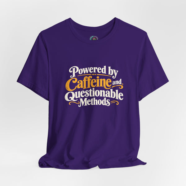 Purple graphic T-shirt, flat lay, Caffeine and Questionable Methods front text