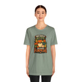 Sage green crewneck T-shirt with centered pumpkin graphic, straight-on view