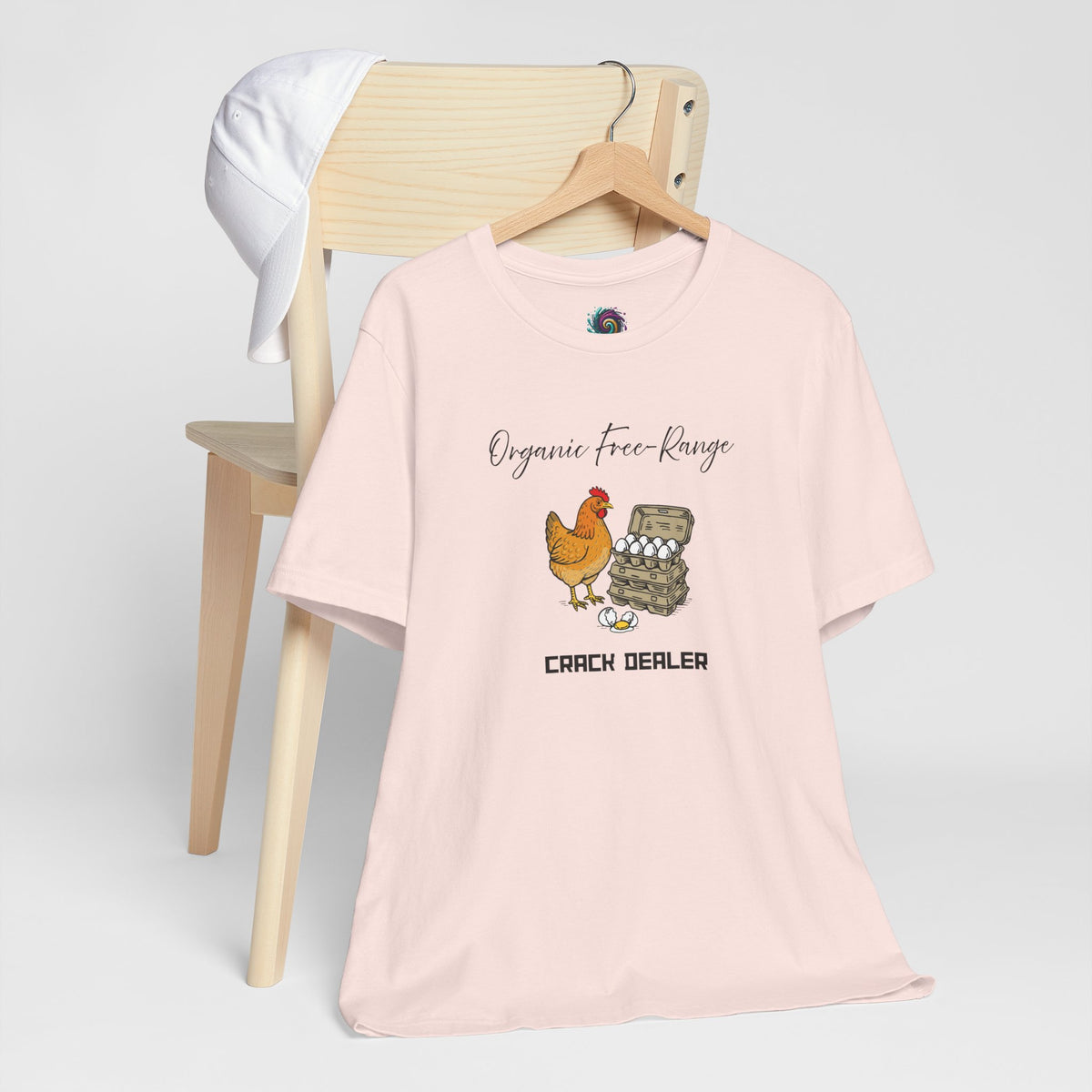 Soft pink crewneck T-shirt with chicken and egg graphic on front, short sleeves