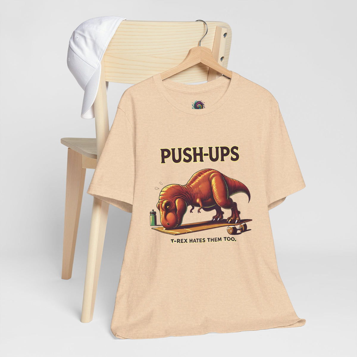 Tan crewneck T-shirt with T-rex 'PUSH-UPS' workout graphic, front view
