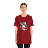 Red crewneck short-sleeve T-shirt with cartoon shark and pink flamingo graphic at center