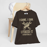 Black T-shirt on wooden hanger with tool-and-text 'I fixed it (eventually)'