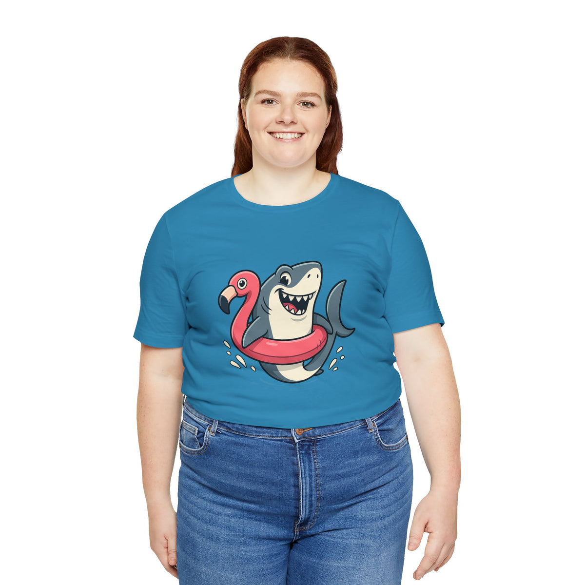 Aqua blue t-shirt with smiling shark and pink flamingo floatie graphic