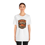White crew-neck T-shirt with “Pumpkin Patch Social Club” pumpkin graphic chest print