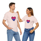 Soft pink Pride heart t-shirt featuring rainbow heart graphic, worn by two people
