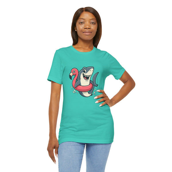 Teal crew-neck T-shirt with shark and flamingo floatie graphic, hand on hip