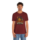 Burgundy crew-neck T-shirt on model, featuring pumpkin and witch graphic