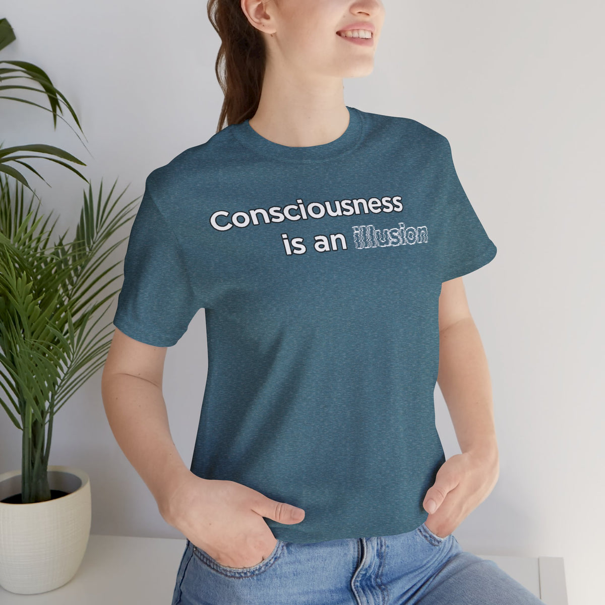Close-up of heathered teal T-shirt showing “Consciousness is an illusion” front print