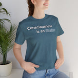 Close-up of heathered teal T-shirt showing “Consciousness is an illusion” front print