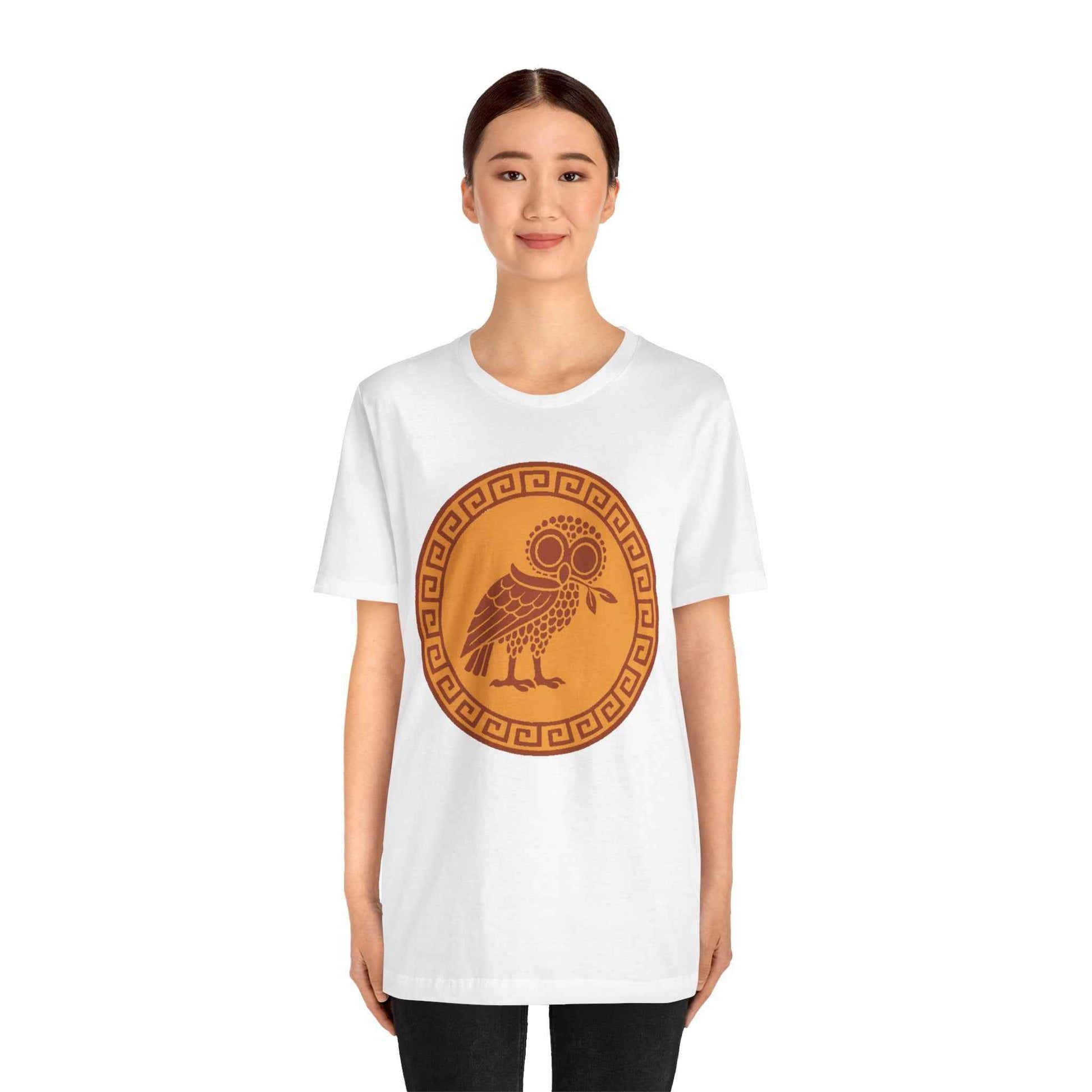 Person wearing a white t-shirt with a brown owl design on a white background