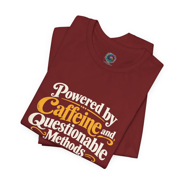 Maroon graphic T-shirt with "Powered by Caffeine and Questionable Methods" logo print, folded