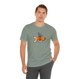 Sage green crew-neck T-shirt with orange fish-and-shark graphic, hands in pockets
