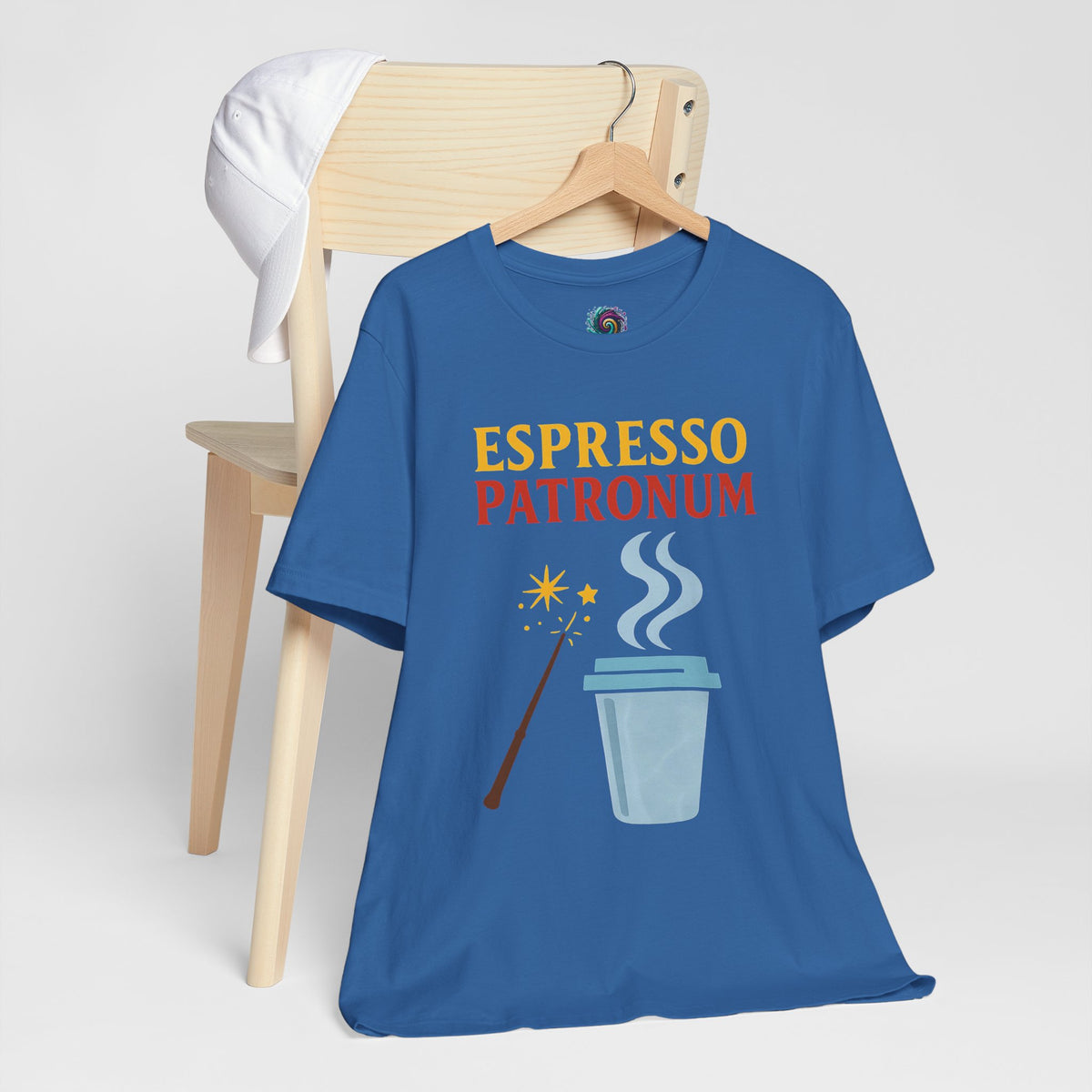 Blue crew-neck T-shirt on wooden hanger with “ESPRESSO PATRONUM” printed front graphic.