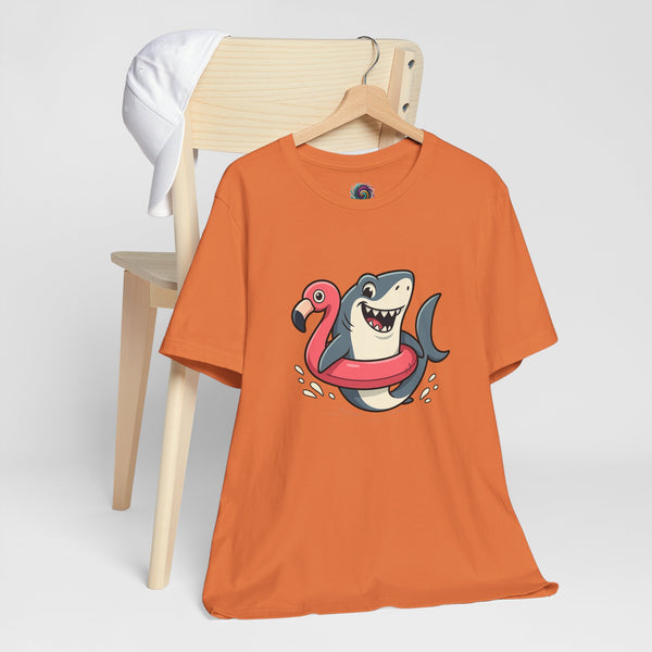 Orange crewneck T-shirt with shark and flamingo floatie graphic on chest.