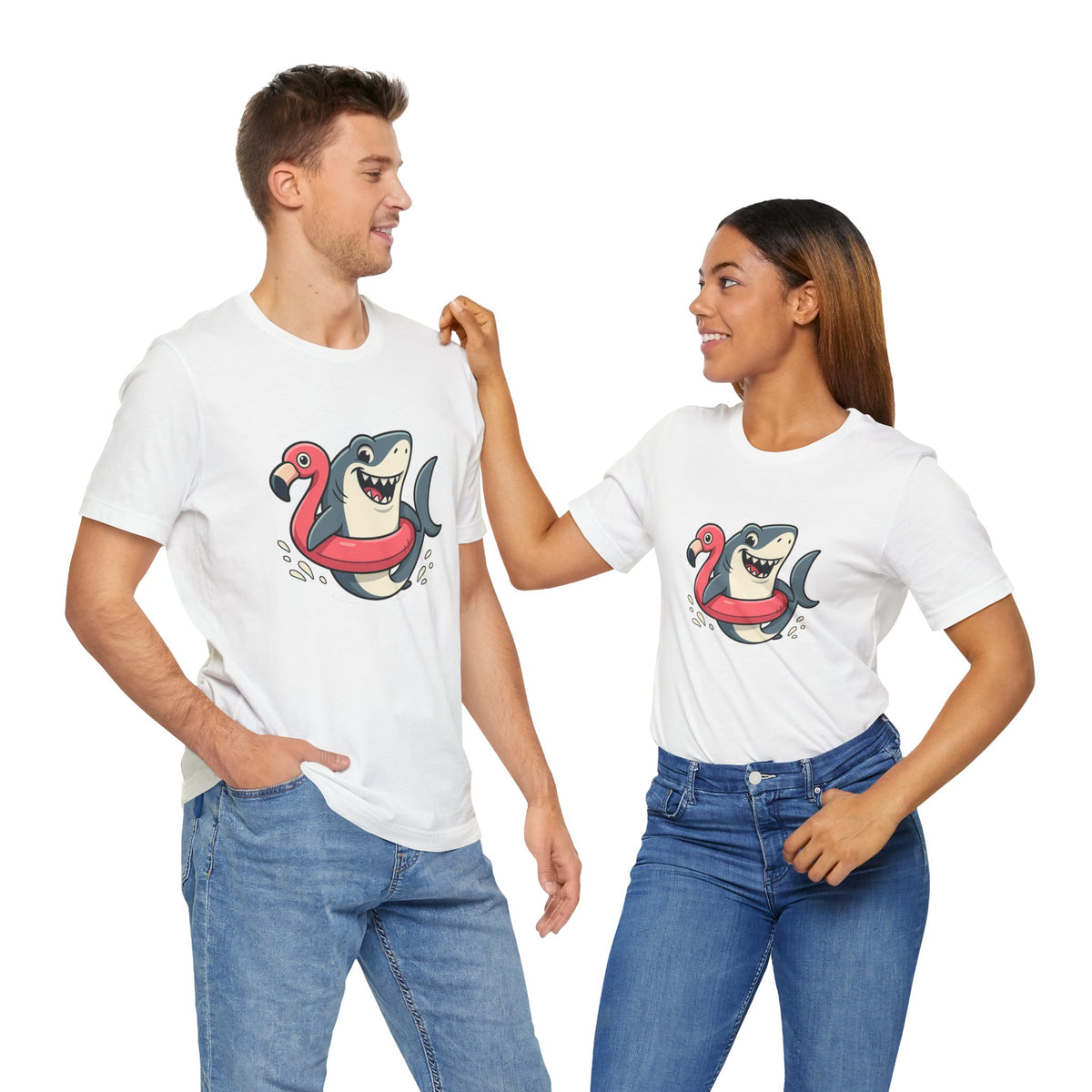 Couple wearing white crew-neck T-shirts with shark riding flamingo float graphic