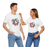 Couple wearing white crew-neck T-shirts with shark riding flamingo float graphic