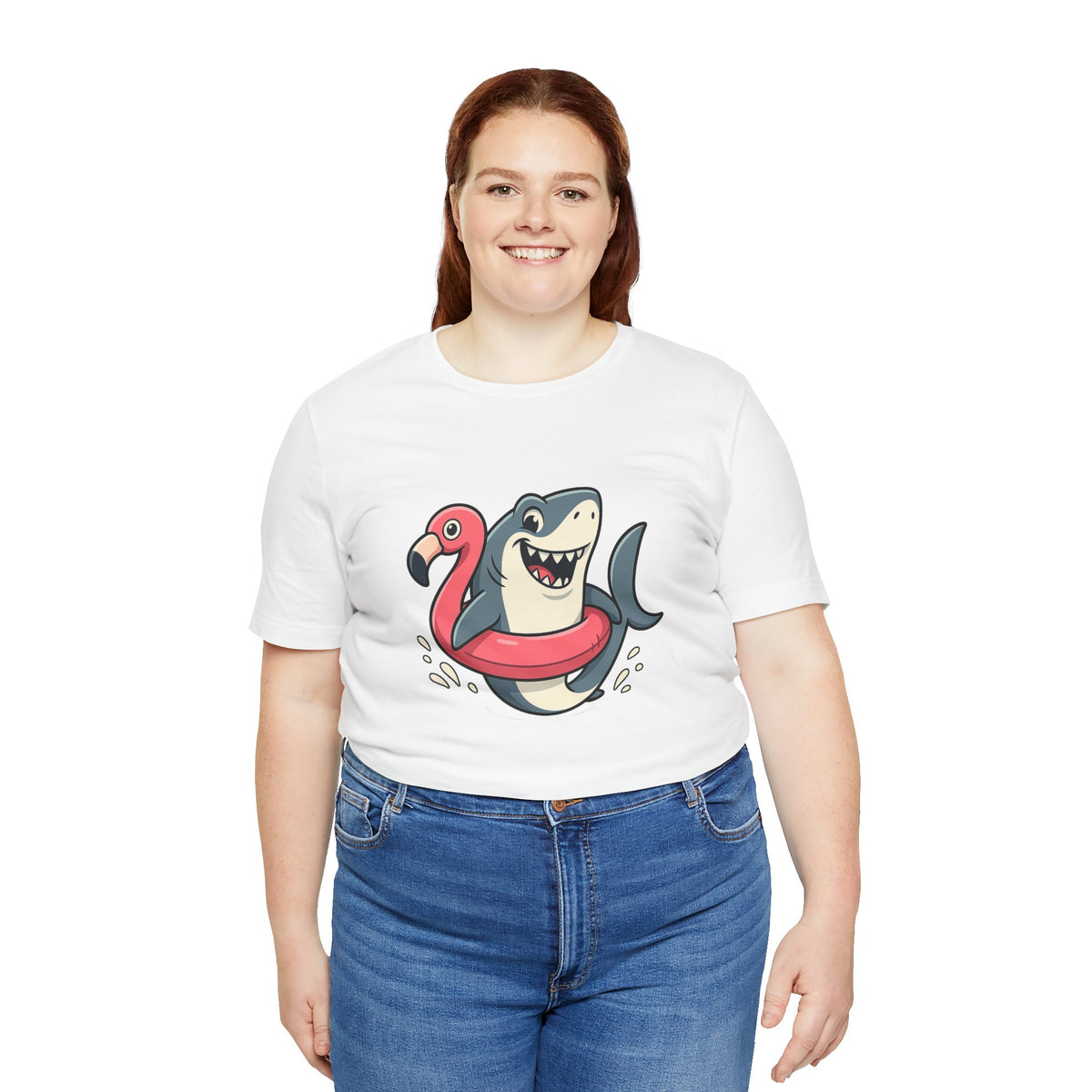 White crew-neck T-shirt with colorful shark riding flamingo float illustration