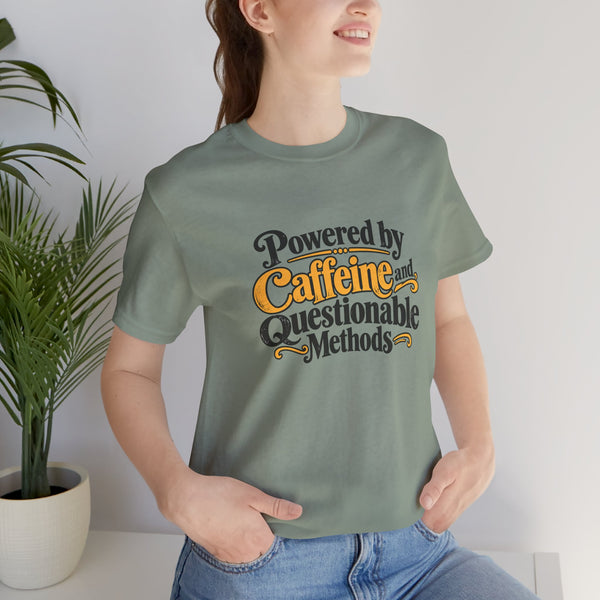 Sage green T-shirt with "Powered by Caffeine and Questionable Methods" chest graphic