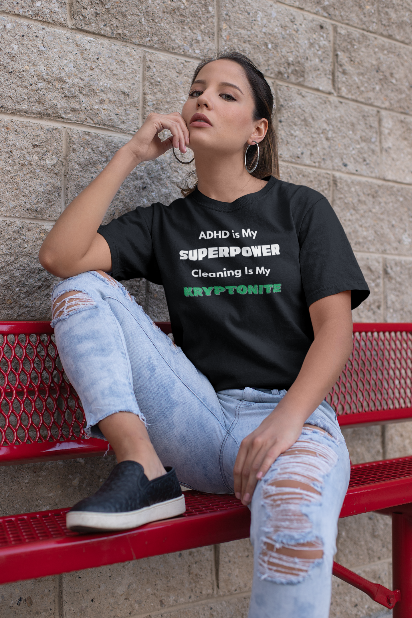 ADHD Cleaning Kryptonite T-Shirt – Funny Shirt for Neurodivergent Humor in black worn by woman in jeans against brick wall