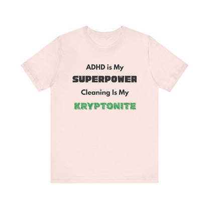 ADHD Cleaning Kryptonite T-Shirt – Funny Shirt for Neurodivergent Humor in soft pink with comic-style ADHD phrase