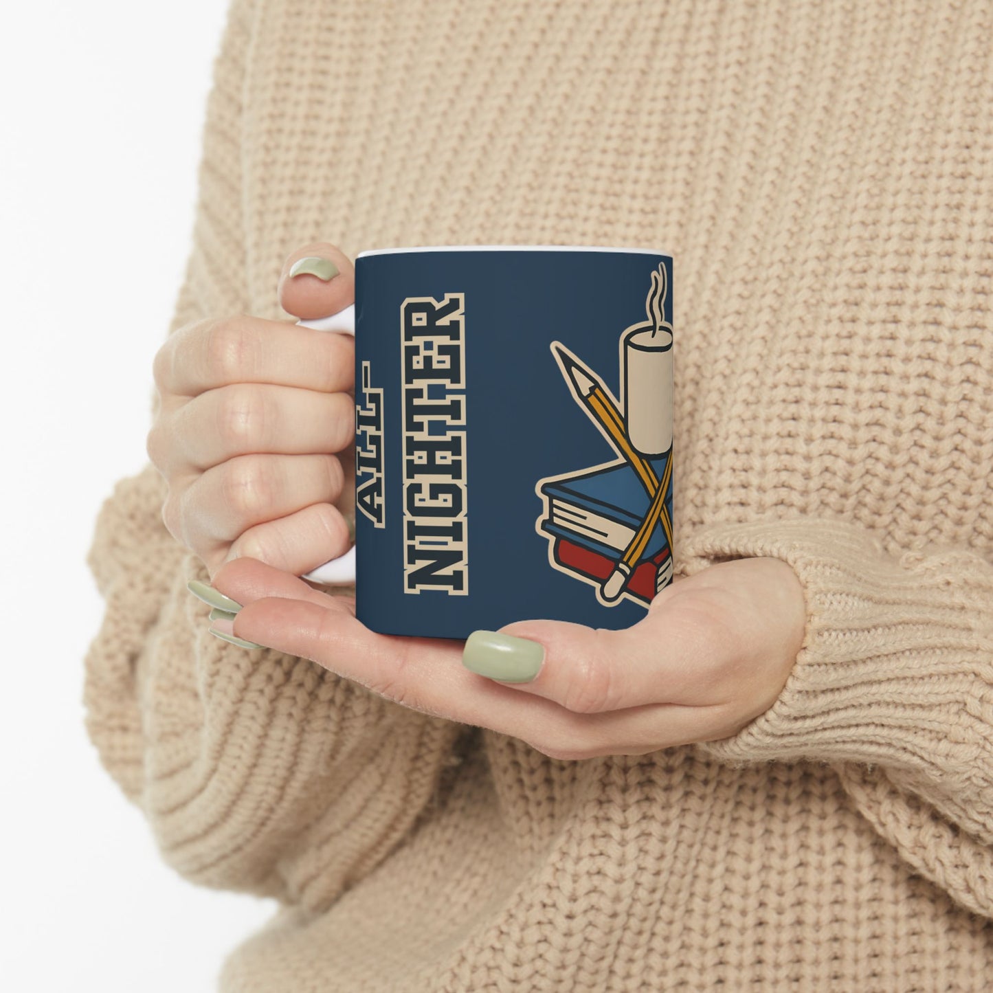 A person wearing a beige knit sweater holds a white mug with the "All-Nighter Club" design, showcasing a stack of books, crossed pencils, and steam rising from a cup—perfect for cozy late-night work sessions.