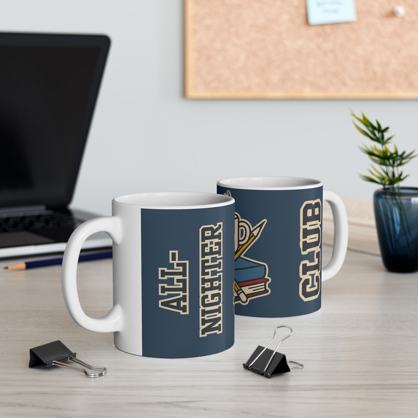 Two white ceramic mugs displaying the "All-Nighter Club" design rest on a clean desk near a laptop, binder clips, and a potted plant, ideal for study nights or coworking energy.