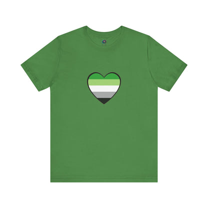 Aromantic Pride T-Shirt – Aromantic Flag Heart Graphic on leaf green flat lay. Aro flag colors pop on the earth-toned base. Keywords: aromantic shirt, aromantic pride merch, aromantic heart.
