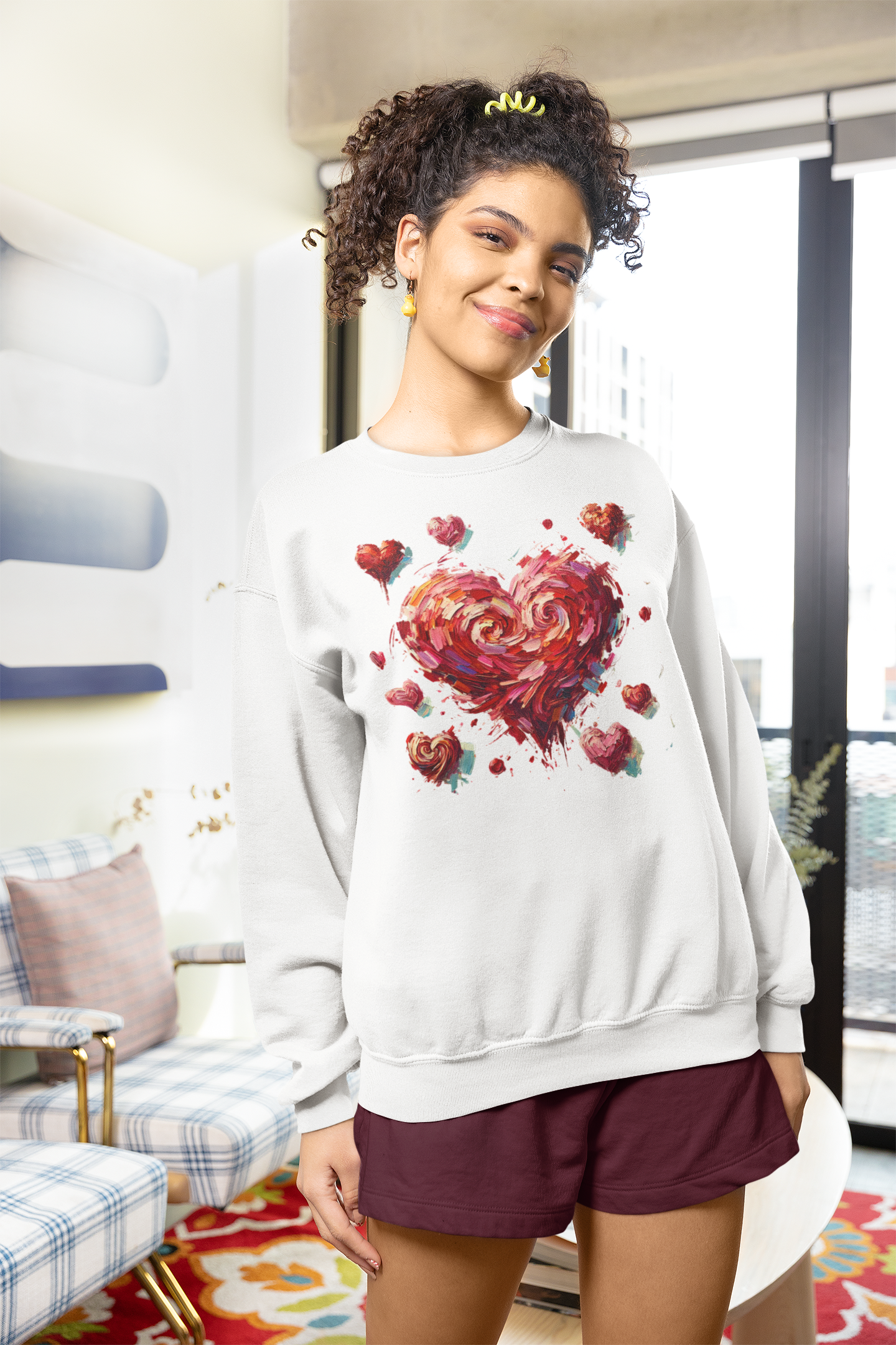 Woman in an apartment wearing the Impressionistic Heart Sweatshirt – Painterly Valentine's Day Art Pullover