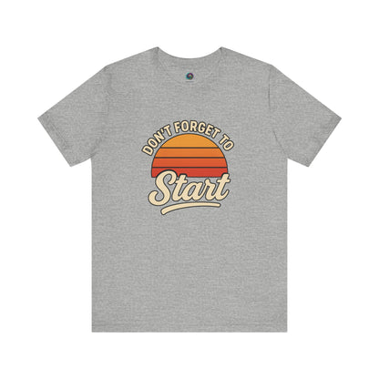Don’t Forget to Start T-Shirt – Motivational Graphic Tee for Dreamers in Athletic Heather flat lay mockup with retro sunset design